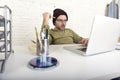 Young attractive hipster businessman working from his home office as freelancer self employed business model Royalty Free Stock Photo