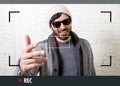 Young attractive hipster and trendy style man in selfie and internet video blogger recording Royalty Free Stock Photo