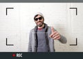 Young attractive hipster and trendy style man in selfie and internet video blogger recording Royalty Free Stock Photo