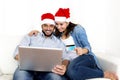 Young attractive Hispanic couple in love online Christmas shopping with computer Royalty Free Stock Photo