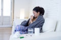 Young attractive hispanic woman lying sick at home couch in cold and flu in gripe disease symptom Royalty Free Stock Photo