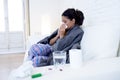 Young attractive hispanic woman lying sick at home couch in cold and flu in gripe disease symptom Royalty Free Stock Photo