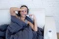 Young attractive hispanic woman lying sick at home couch in cold and flu in gripe disease symptom Royalty Free Stock Photo