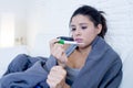 Young attractive hispanic woman lying sick at home couch in cold and flu in gripe disease symptom