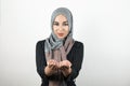 Young attractive hopeful Muslim woman wearing turban hijab, headscarf holding her hands together isolated white Royalty Free Stock Photo