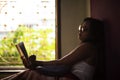 Young  Indian woman standing in front of a window/balcony Royalty Free Stock Photo