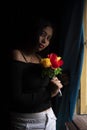 Young  Indian woman standing in front of a window/balcony Royalty Free Stock Photo