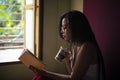 Young  Indian woman standing in front of a window/balcony Royalty Free Stock Photo