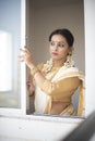 Portrait of an young and attractive Indian woman in white traditional wear  for the celebration of Onam/Pongal Royalty Free Stock Photo