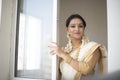 Portrait of an young and attractive Indian woman in white traditional wear  for the celebration of Onam/Pongal Royalty Free Stock Photo