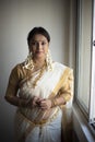 Portrait of an young and attractive Indian woman in white traditional wear  for the celebration of Onam/Pongal Royalty Free Stock Photo