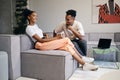 Young attractive joyful African American couple happily talking during coffee break in co-working space Royalty Free Stock Photo