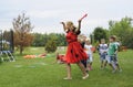 Young attractive kindergarten teacher dancing with children at the playground Royalty Free Stock Photo