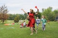 Young attractive kindergarten teacher dancing with children at the playground Royalty Free Stock Photo