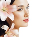 Young attractive lady close up with hands on face isolated flower lily brunette spa Royalty Free Stock Photo