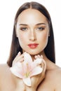 Young attractive lady close up with hands on face isolated flower lily brunette spa nude makeup Royalty Free Stock Photo