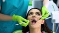 Young attractive lady at regular checkup in dentistry clinic, oral cavity health Royalty Free Stock Photo