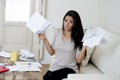 Young attractive latin woman at home living room couch calculating monthly expenses worried in stress Royalty Free Stock Photo