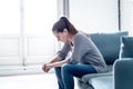 Young woman suffering from depression feeling sad and lonely on sofa at home Royalty Free Stock Photo