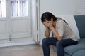 Latin woman lying at home sitting on couch crying worried suffering depression feeling sad Royalty Free Stock Photo