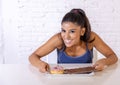 Portrait of young happy woman eating delighted chocolate bar and donuts Royalty Free Stock Photo