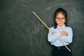 Attractive little female teacher holding stick