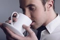 Young attractive macho drinking coffe
