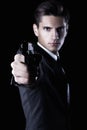 Young attractive macho in suit with gun Royalty Free Stock Photo