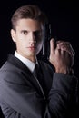 Young attractive macho in suit with gun Royalty Free Stock Photo