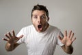 Young attractive man astonished amazed in shock surprise face expression and shock emotion Royalty Free Stock Photo