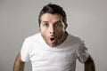 Young attractive man astonished amazed in shock surprise face expression and shock emotion Royalty Free Stock Photo