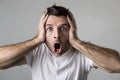 Young attractive man astonished amazed in shock surprise face expression and shock emotion Royalty Free Stock Photo