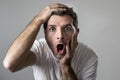 Young attractive man astonished amazed in shock surprise face expression and shock emotion Royalty Free Stock Photo