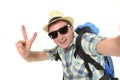 Young attractive man or backpacker student taking selfie photo with mobile phone or camera Royalty Free Stock Photo