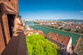 Young attractive man enjoying the view to old city center of Basel from Munster cathedral, Switzerland, Europe