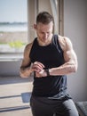 Young man in gym checking sports watch Royalty Free Stock Photo