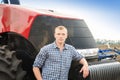 Young attractive man near a tractor. Concept of agriculture Royalty Free Stock Photo