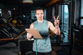 young attractive man personal trainer planning workout with clipboard in gym Royalty Free Stock Photo