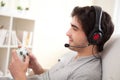 Young attractive man playing video games in a sofa Royalty Free Stock Photo