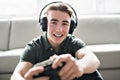 Young attractive man playing video games in the livingroom Royalty Free Stock Photo