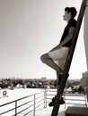 Young attractive man posing in front of camera on the roof of a residential building standing on a ladder