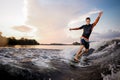 Young attractive man riding on the green wakeboard Royalty Free Stock Photo