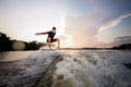 Young attractive man riding on the wakeboard on the background o Royalty Free Stock Photo