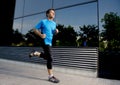 Young attractive man running and training on urban street background on summer workout in sport practice Royalty Free Stock Photo