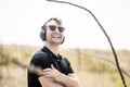 Young attractive man with sunglasses enjoying music on his headphones Royalty Free Stock Photo