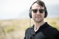 Young attractive man with sunglasses enjoying music on his headphones Royalty Free Stock Photo