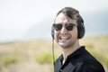 Young attractive man with sunglasses enjoying music on his headphones Royalty Free Stock Photo