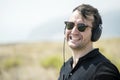 Young attractive man with sunglasses enjoying music on his headphones Royalty Free Stock Photo