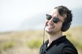 Young attractive man with sunglasses enjoying music on his headphones Royalty Free Stock Photo