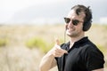 Young attractive man with sunglasses enjoying music on his headphones Royalty Free Stock Photo